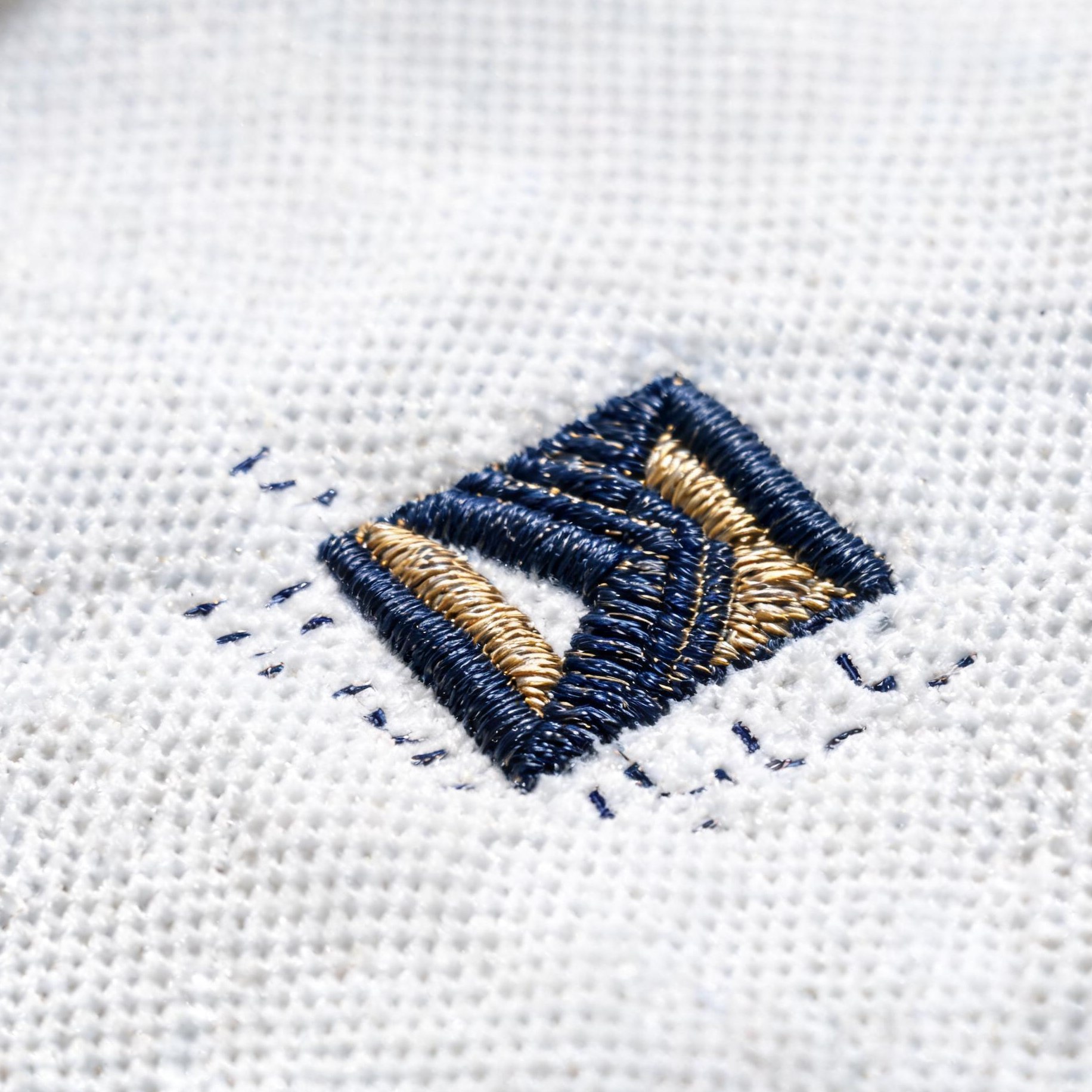 Finished embroidered logo on premium polo shirt fabric